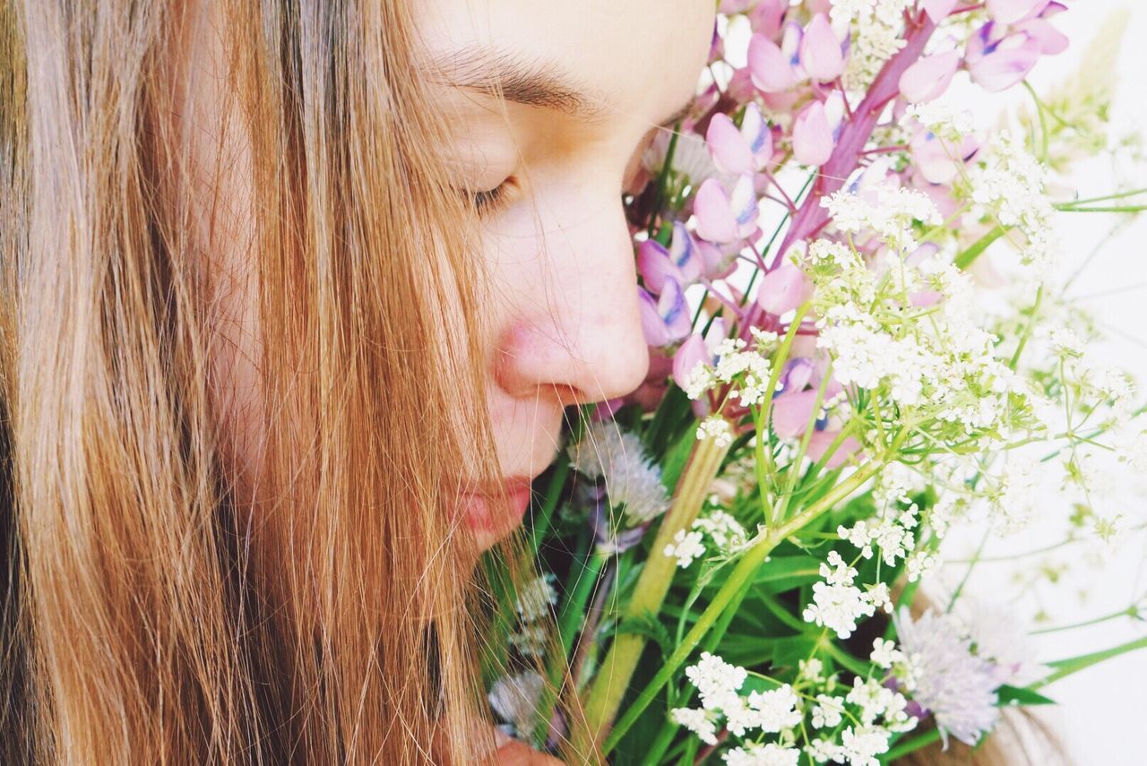 Close-up of woman with flowers