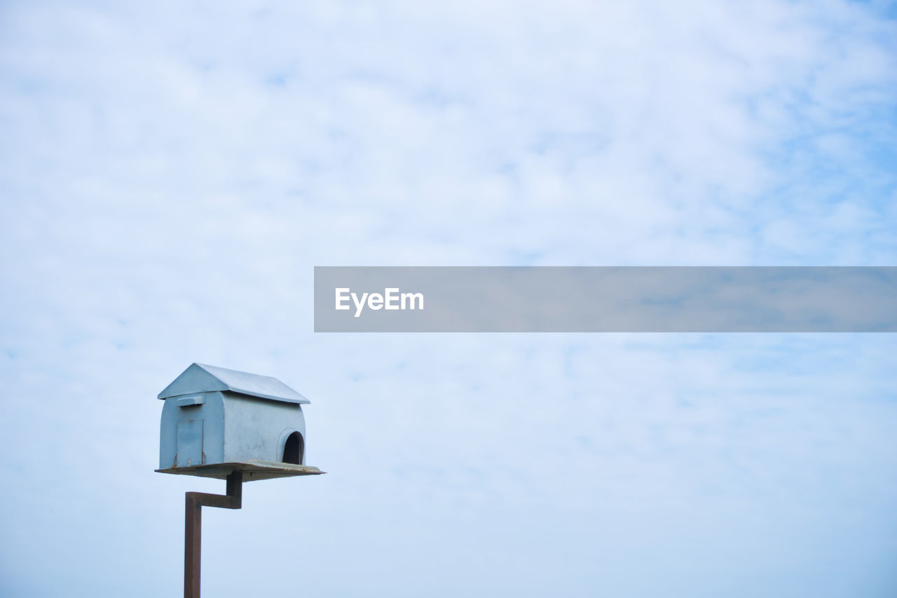 Low angle view of birdhouse against sky