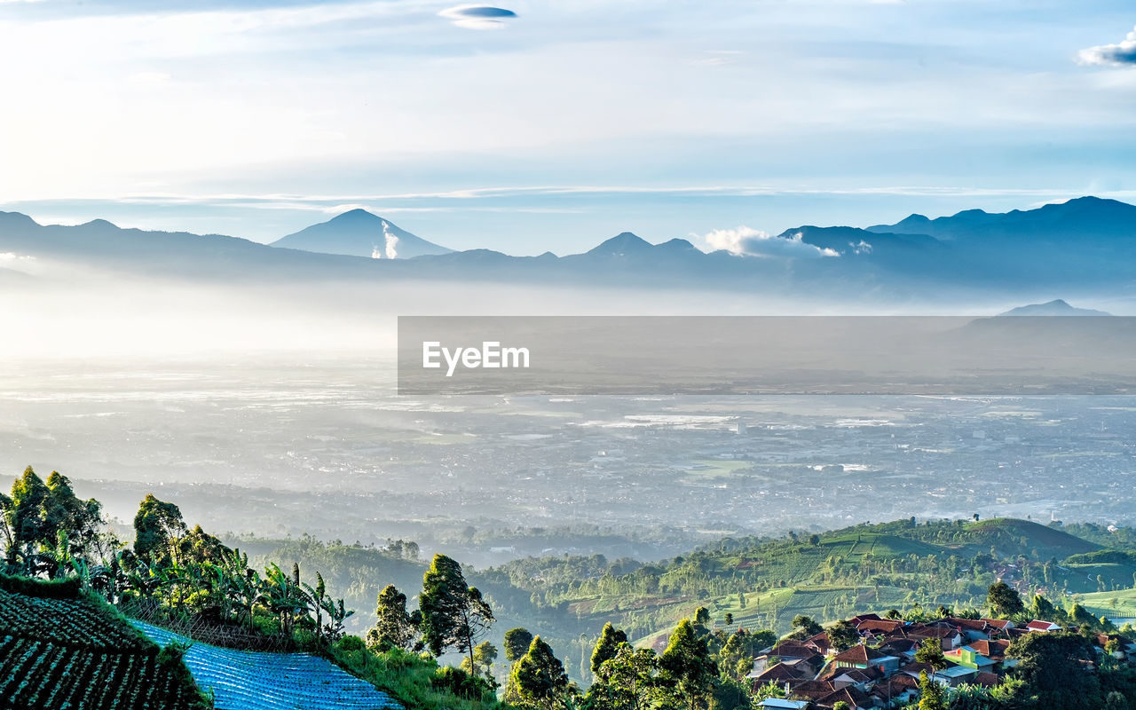 Scenic view of landscape and mountains against sky