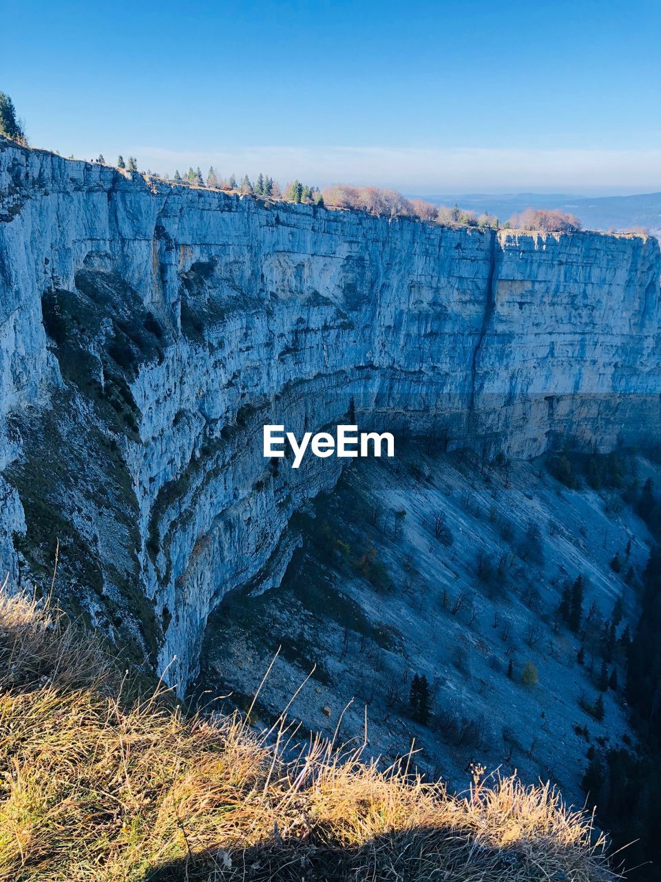 Scenic view of rock formations against blue sky