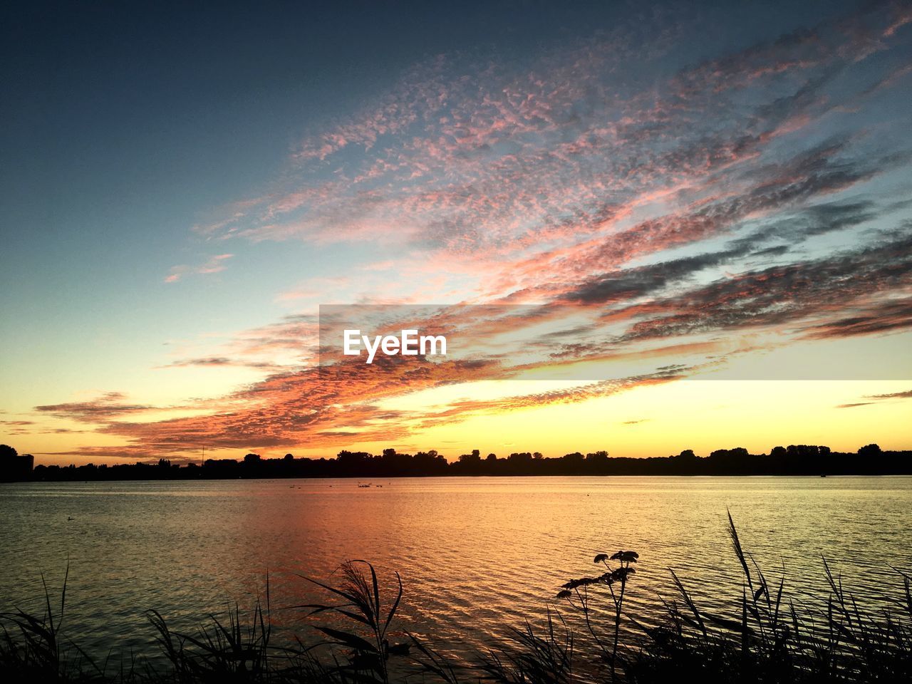 VIEW OF LAKE AGAINST SKY DURING SUNSET