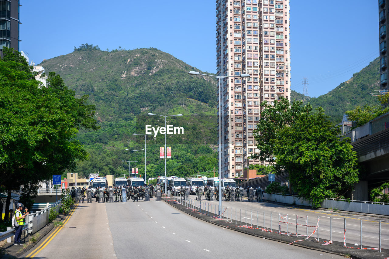 Road by city against clear sky