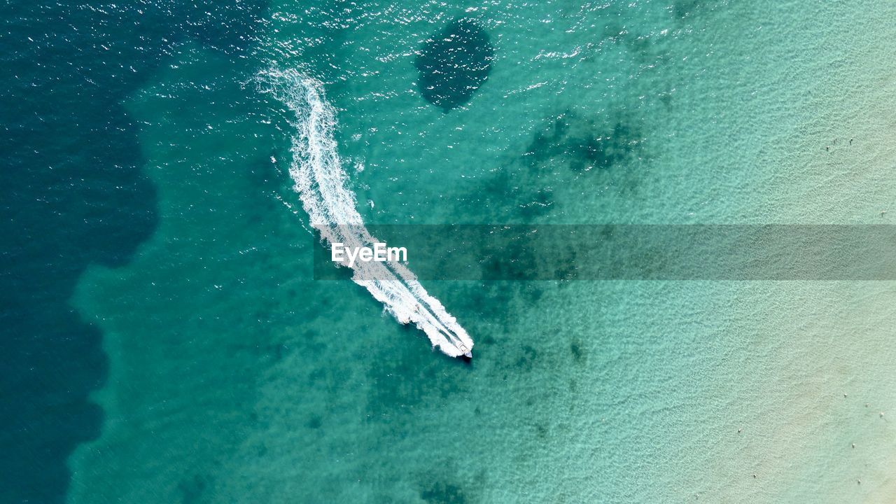 HIGH ANGLE VIEW OF PERSON IN SEA