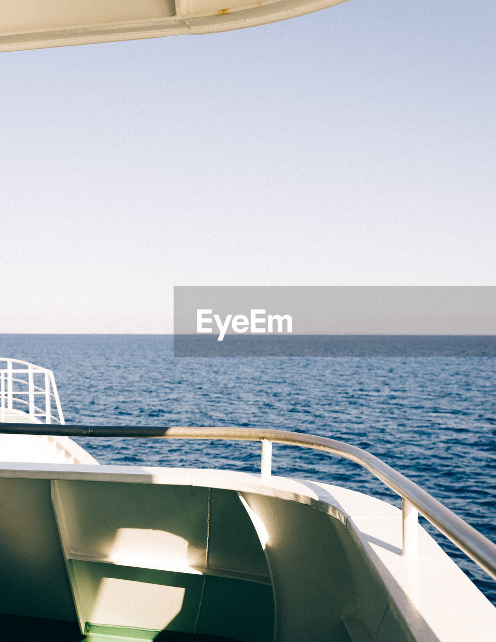 CLOSE-UP OF SHIP SAILING IN SEA AGAINST CLEAR SKY