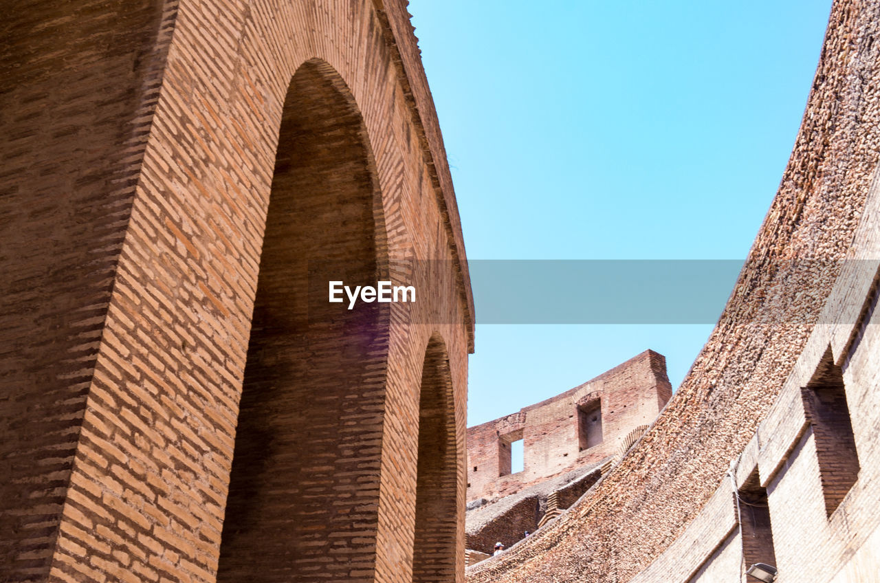 Low angle view of colosseum against clear sky