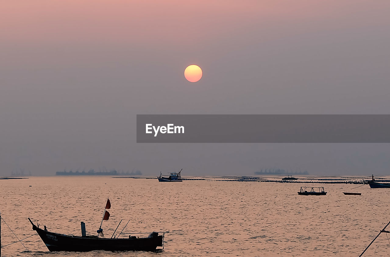 SCENIC VIEW OF SEA AGAINST MOON AT SUNSET