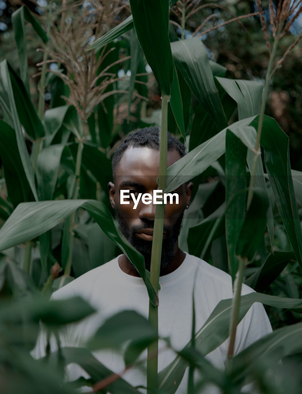 Portrait of young woman amidst plants