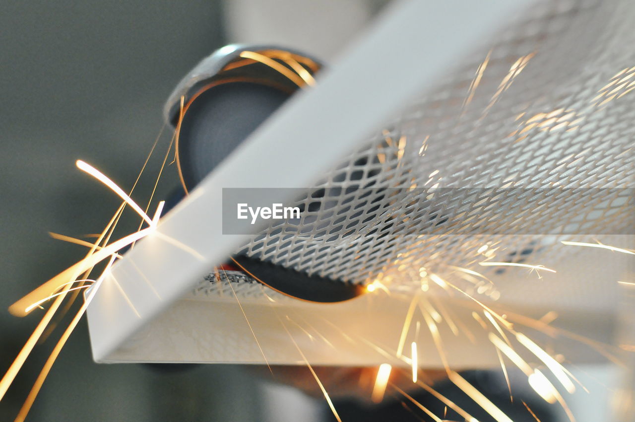 Close-up of circular saw cutting sheet metal at workshop