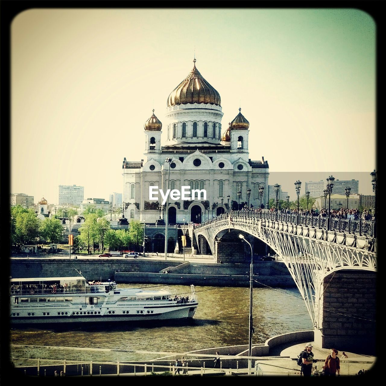 Ferry boat sailing on river by cathedral of christ the saviour against clear sky