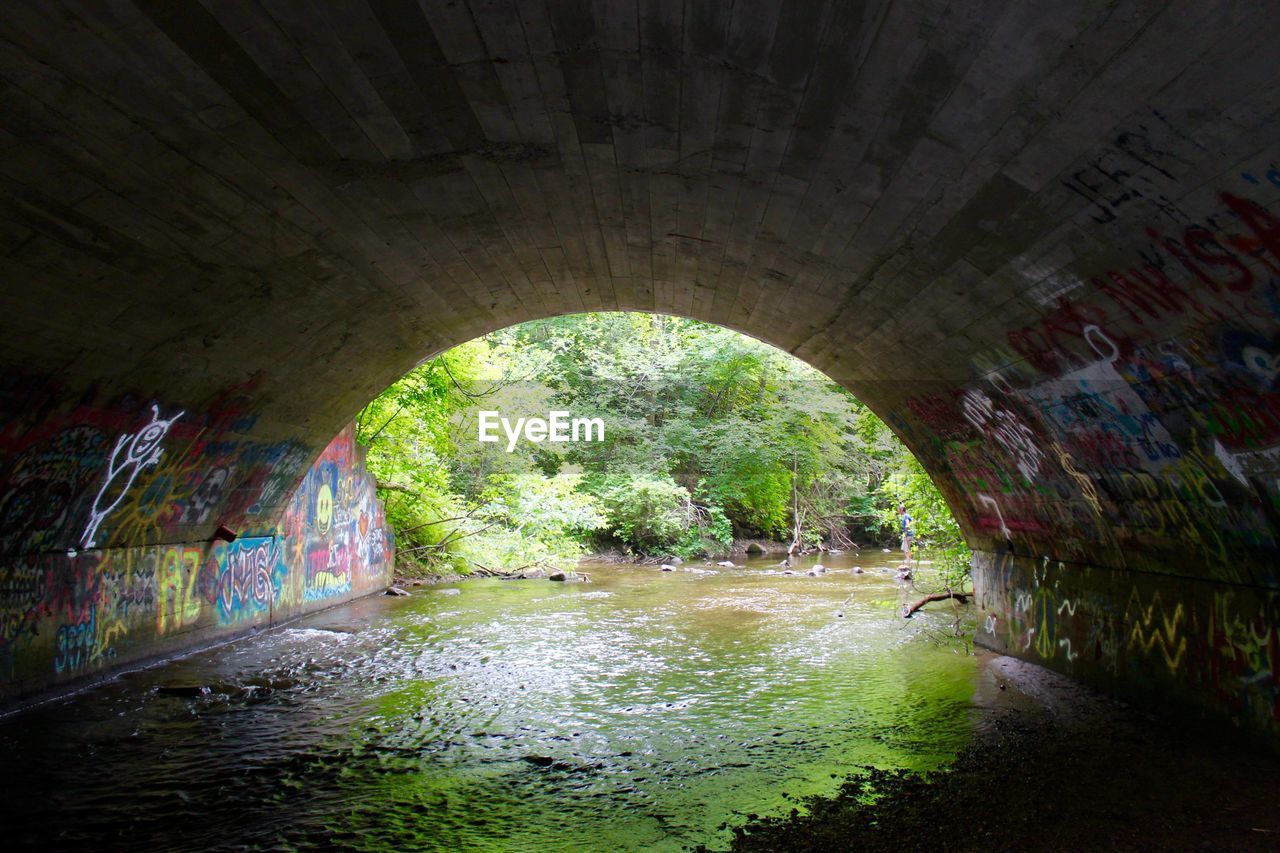 VIEW OF TUNNEL WITH BRIDGE IN BACKGROUND