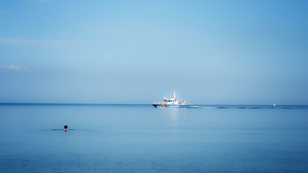 Boat moving on sea against blue sky