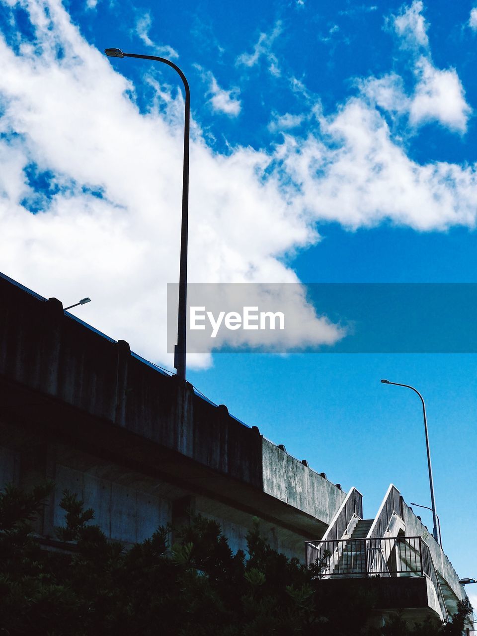 LOW ANGLE VIEW OF BUILDINGS AGAINST BLUE SKY