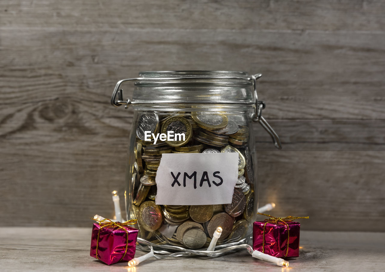 jar, text, mason jar, container, wood, western script, indoors, no people, lighting, candle, food and drink, communication, studio shot, celebration, food, copy space, table, label, still life