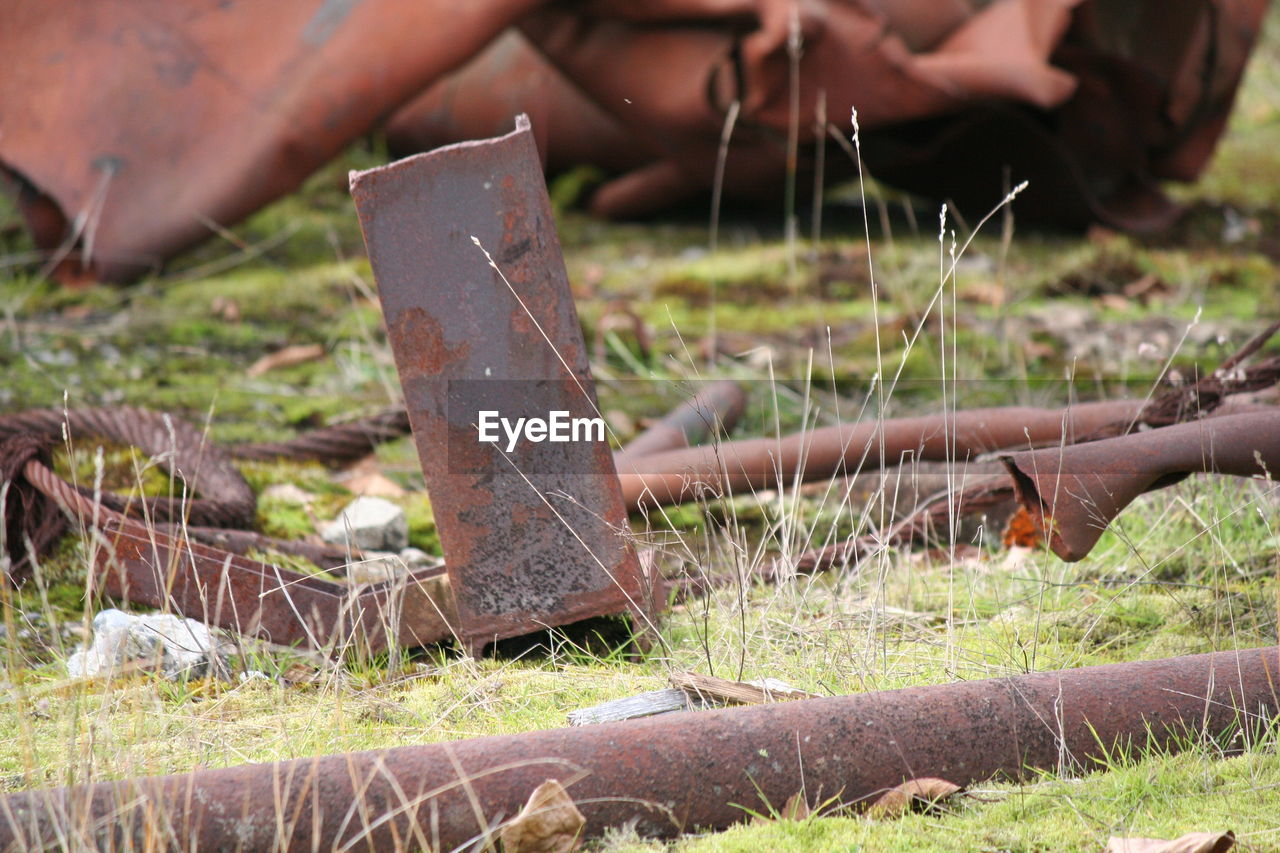Close-up of rusty metal on field