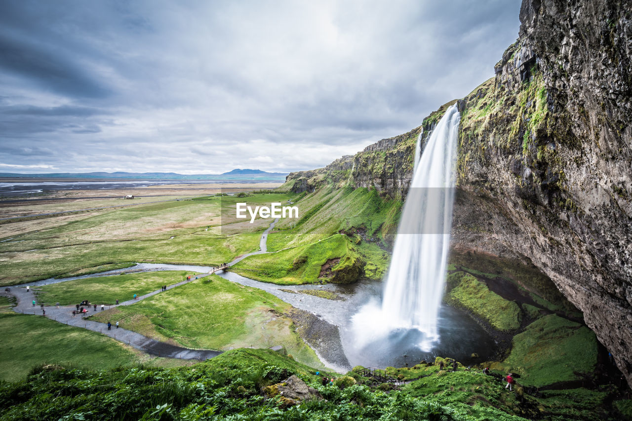 Scenic view of mountains against cloudy sky