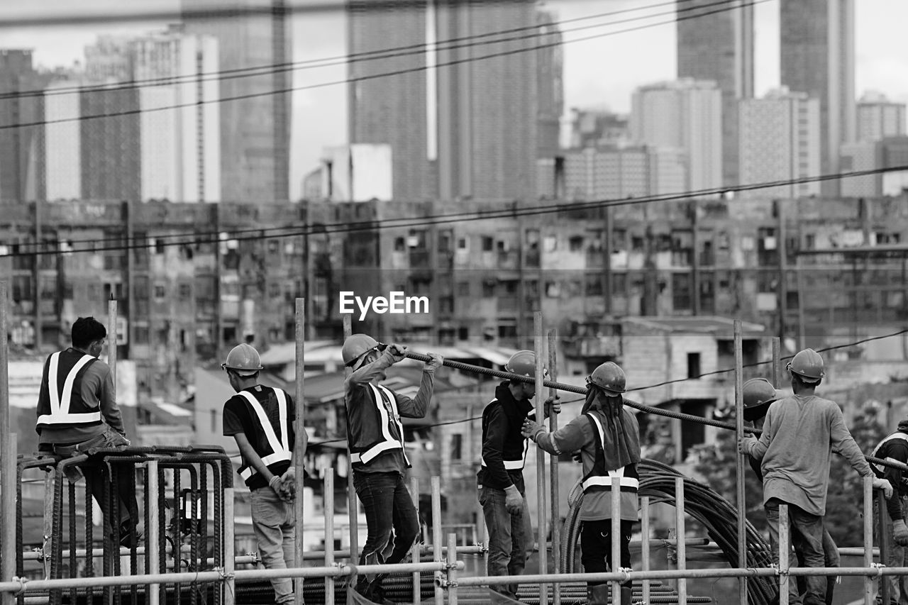 GROUP OF PEOPLE IN FRONT OF BUILDINGS