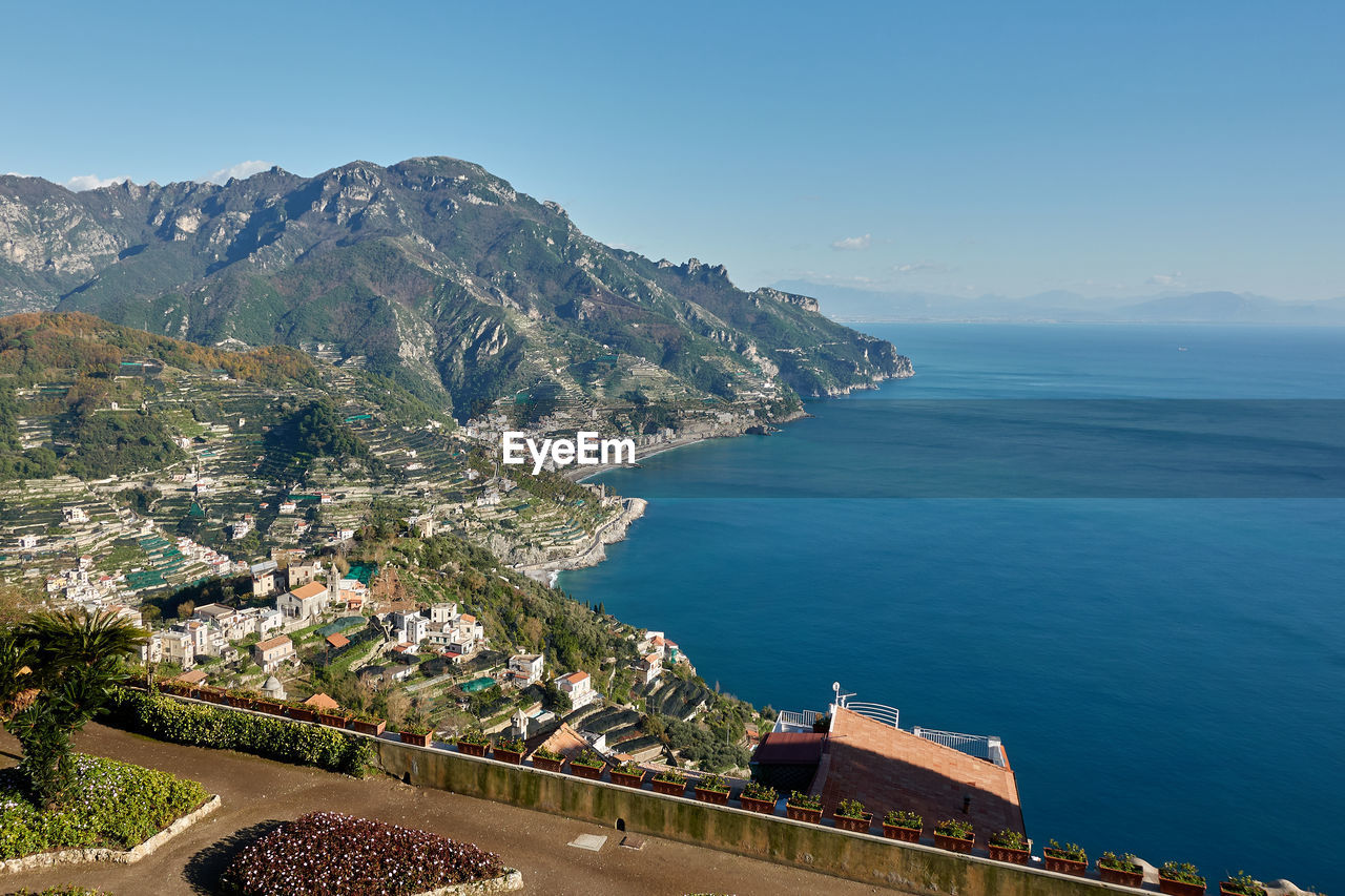 High angle view of buildings by sea against sky