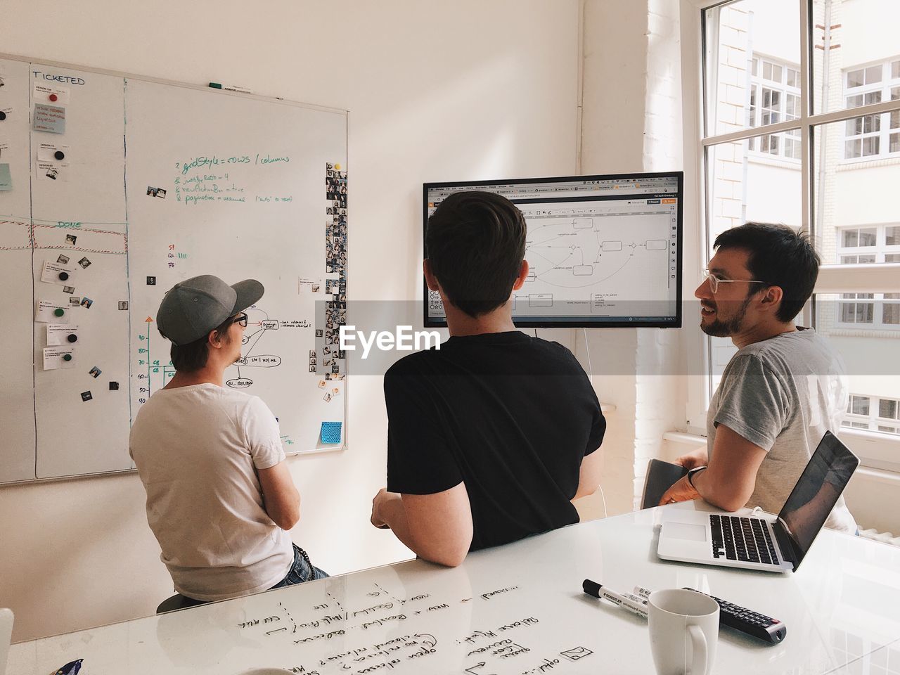 PEOPLE WORKING ON TABLE IN OFFICE