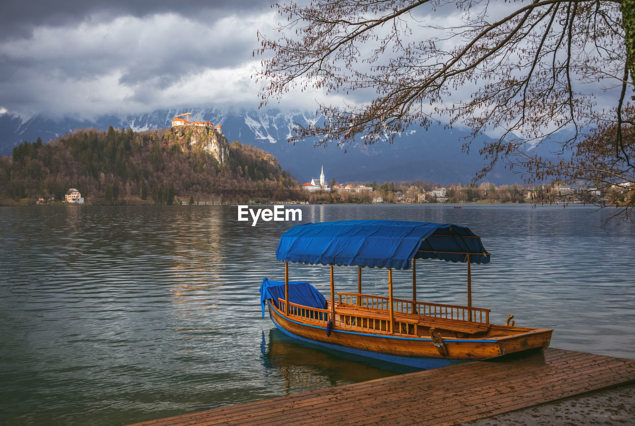 Scenic view of a boat and a lake against sky 