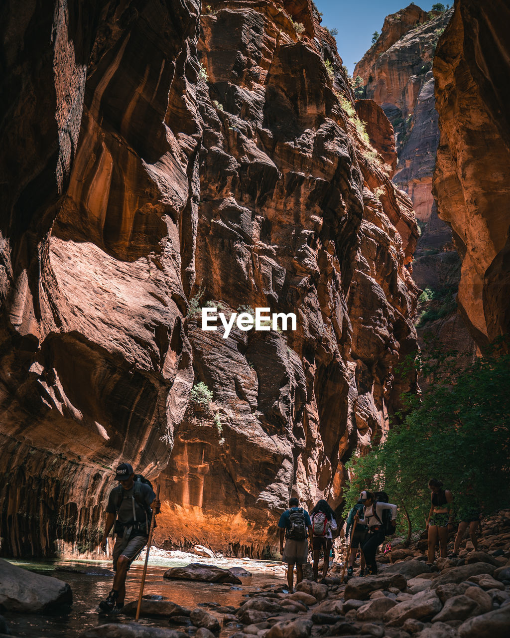 PEOPLE WALKING ON ROCK FORMATION