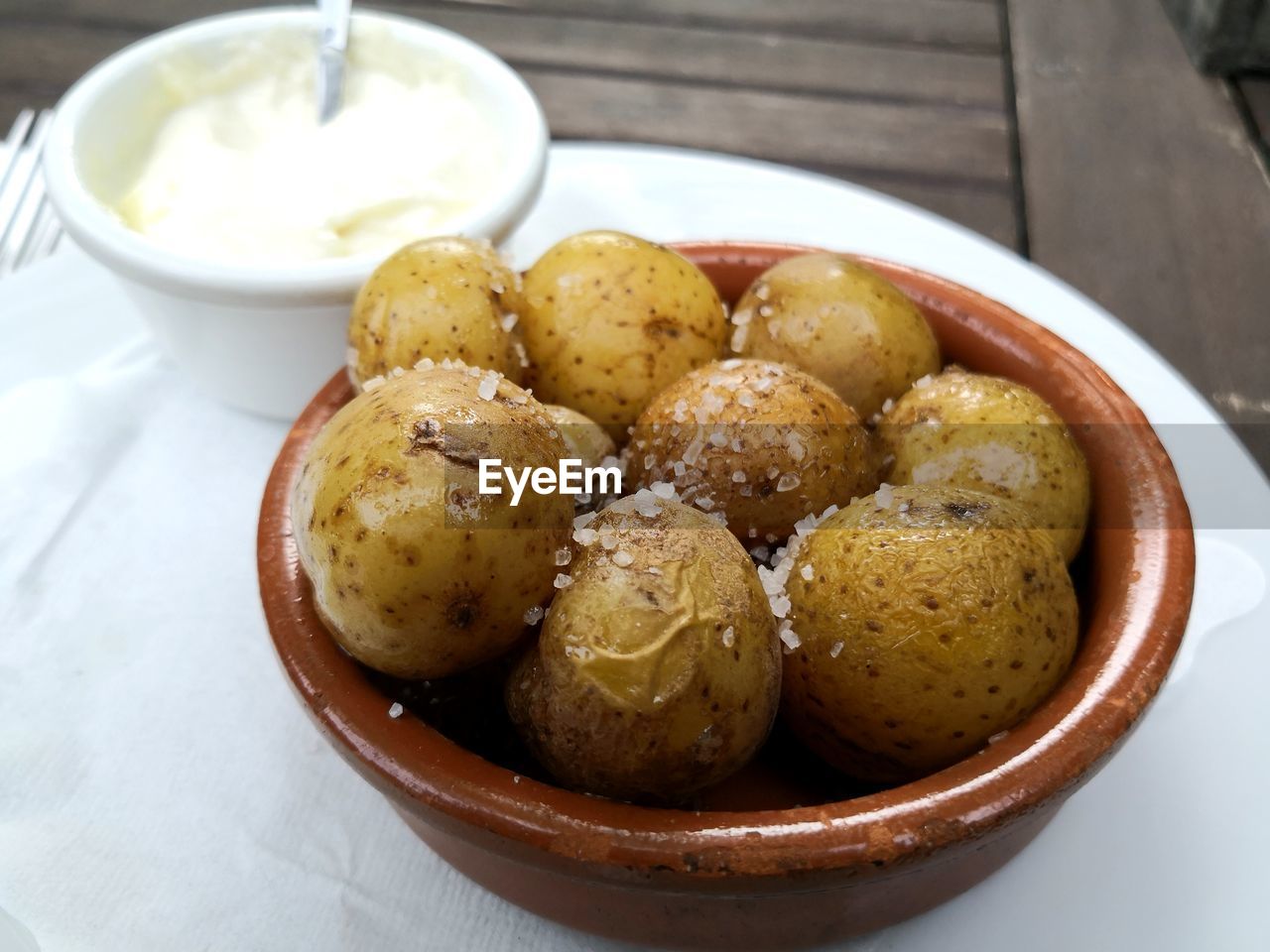 Papas arrugadas spanish tapas salty potatoes with aioli sauce in pot