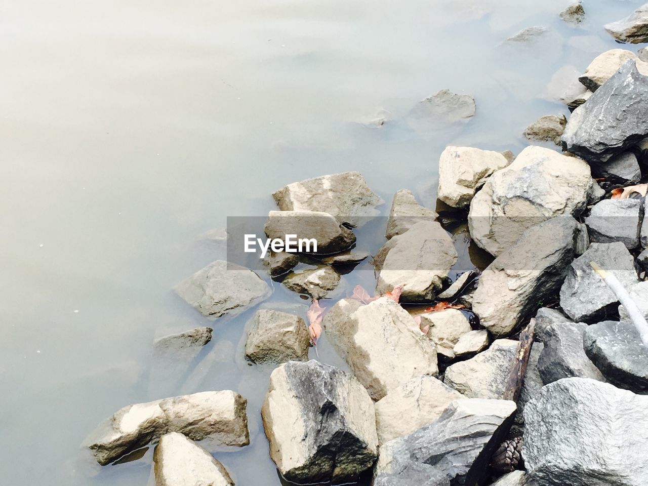 High angle view of rocks at lakeshore