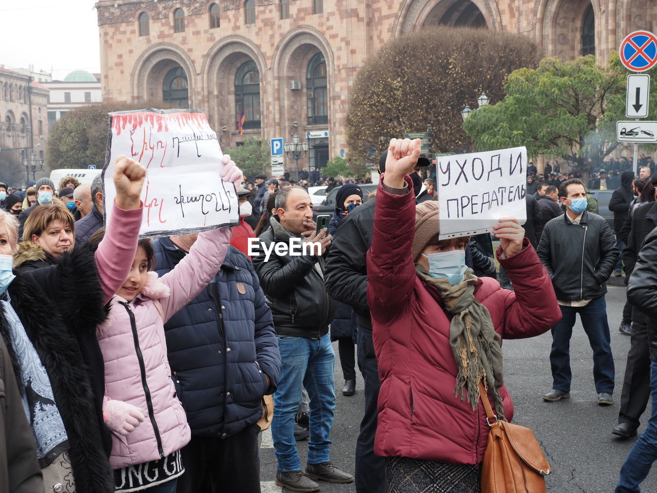 GROUP OF PEOPLE IN FRONT OF CITY