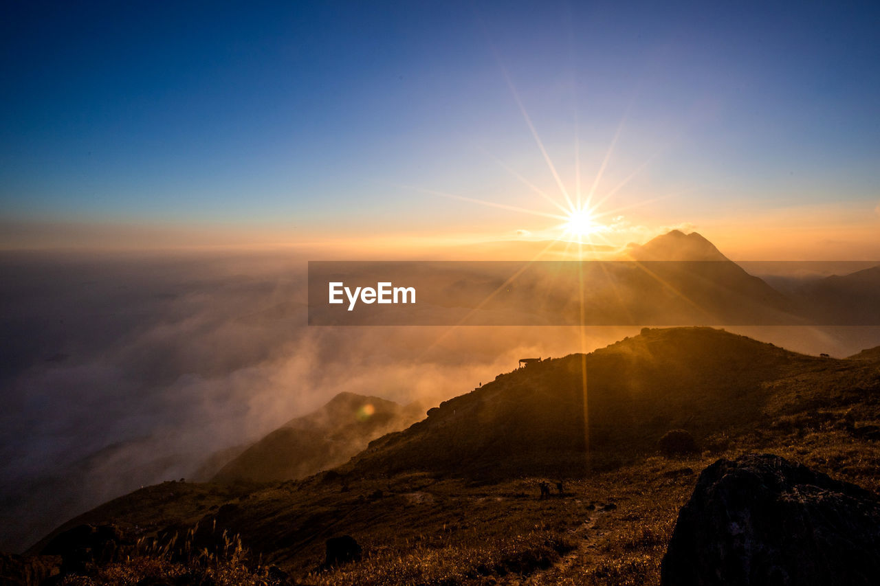 SCENIC VIEW OF MOUNTAIN AGAINST SKY DURING SUNSET