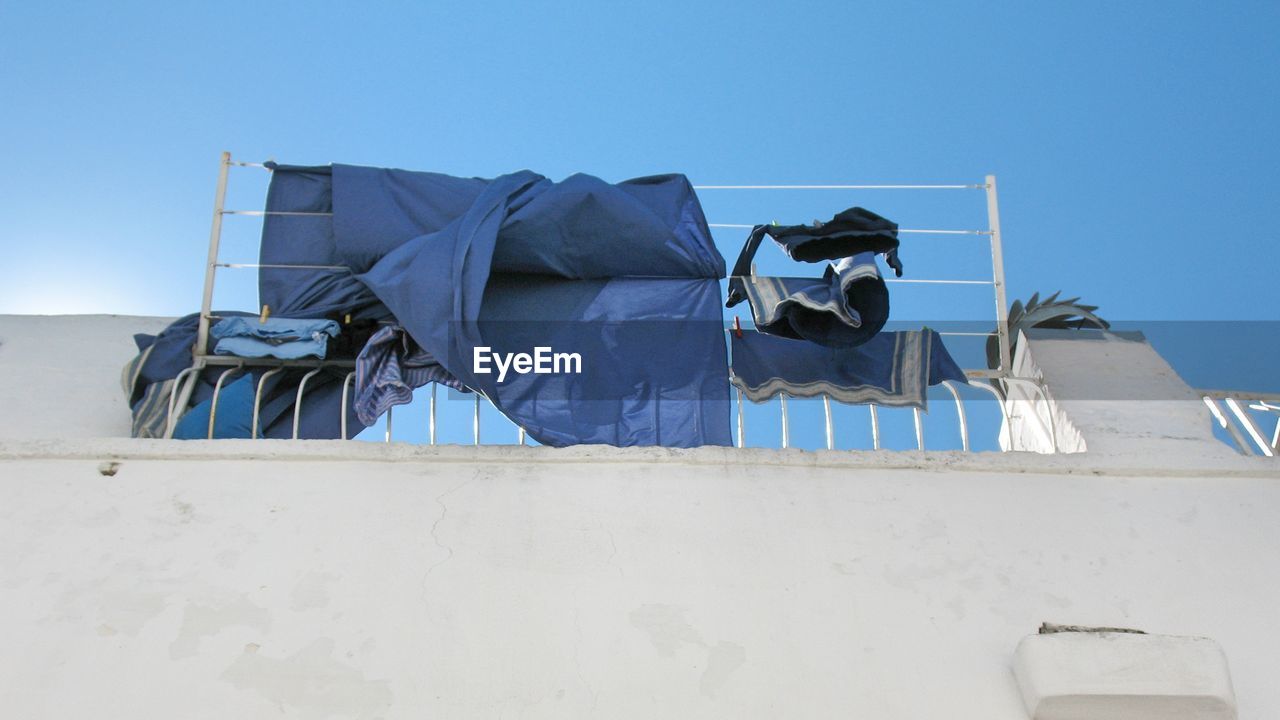 Low angle view of fabrics on building terrace