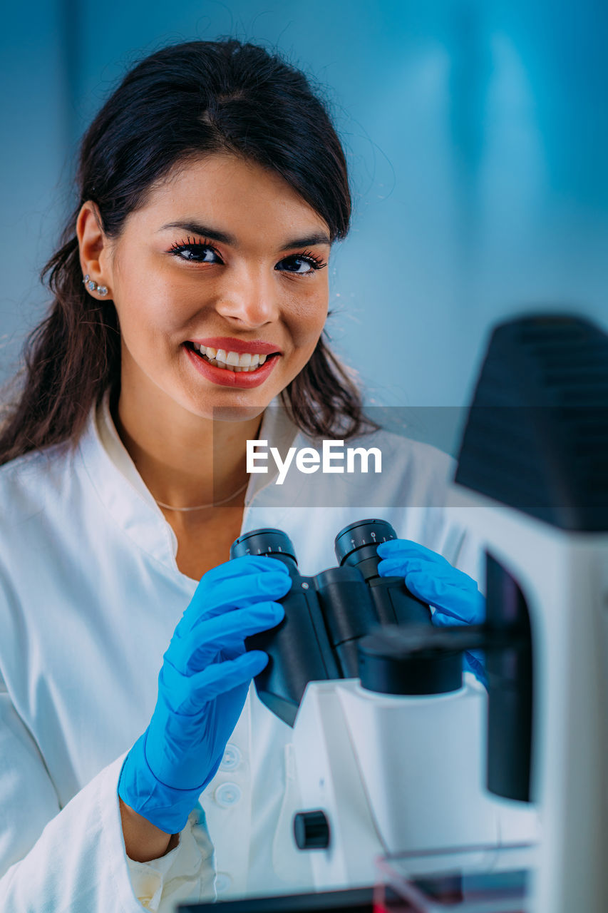 Biology student researcher looking through the microscope