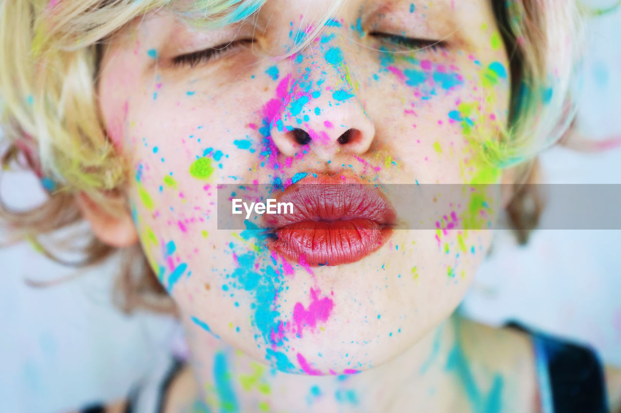 Close-up of woman with powder paint on her face