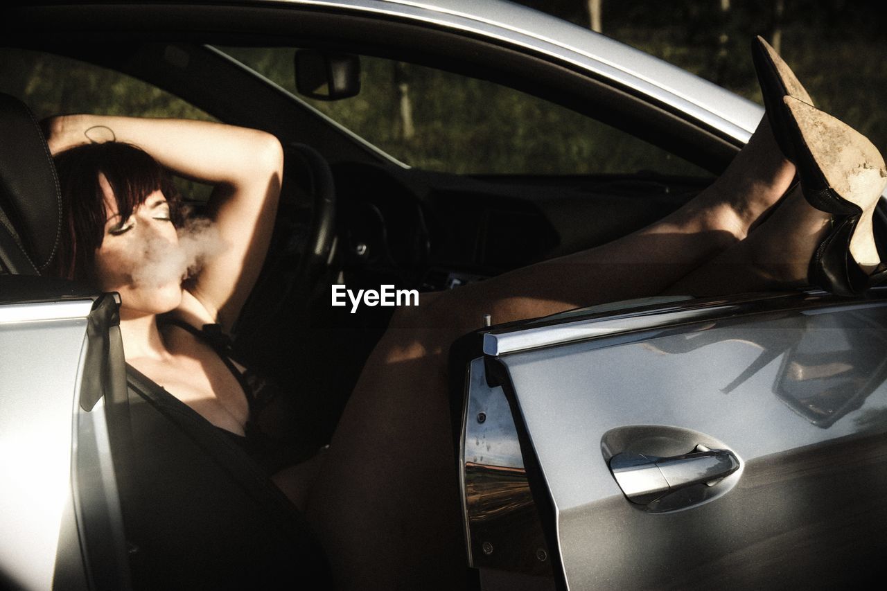 CLOSE-UP OF WOMAN HAND WITH CAR IN MIRROR