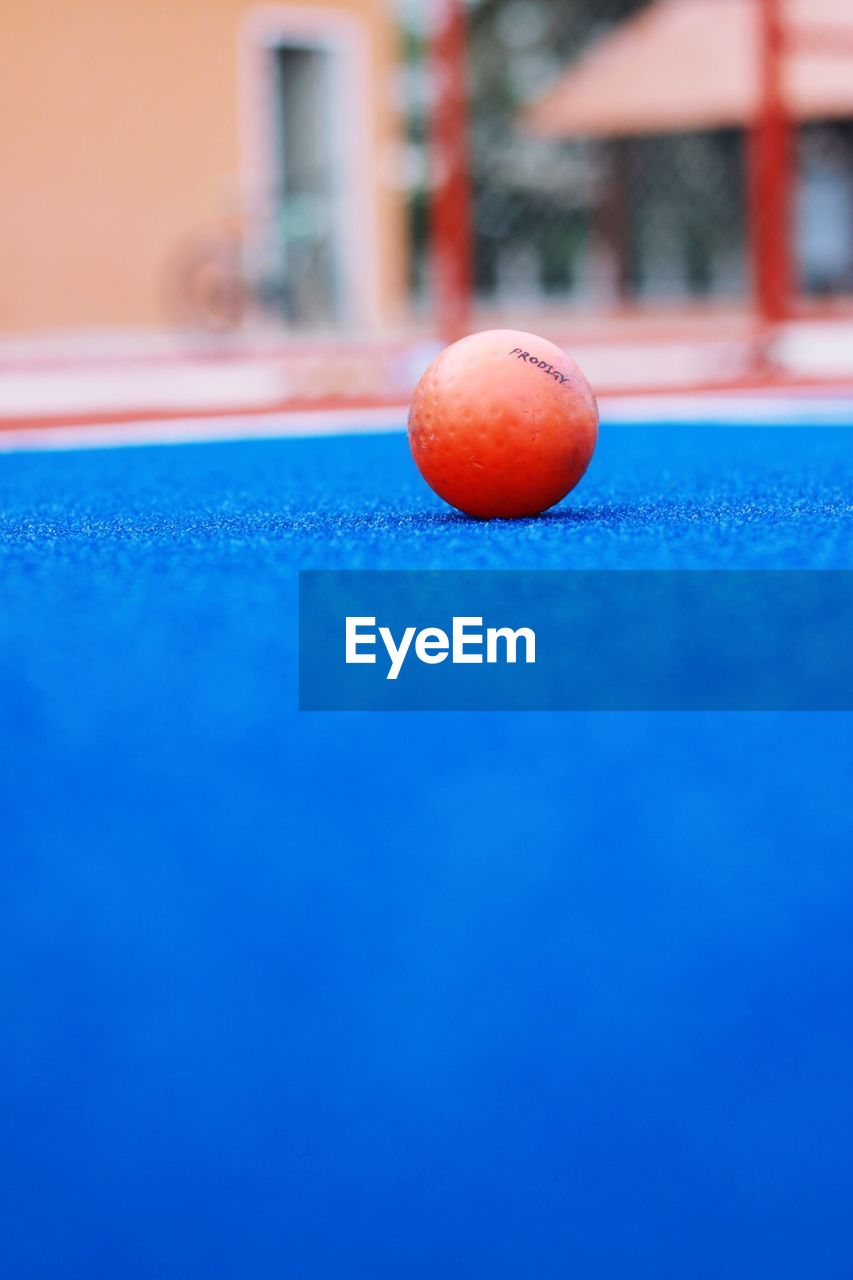 CLOSE-UP OF BLUE BALL AND SWIMMING POOL