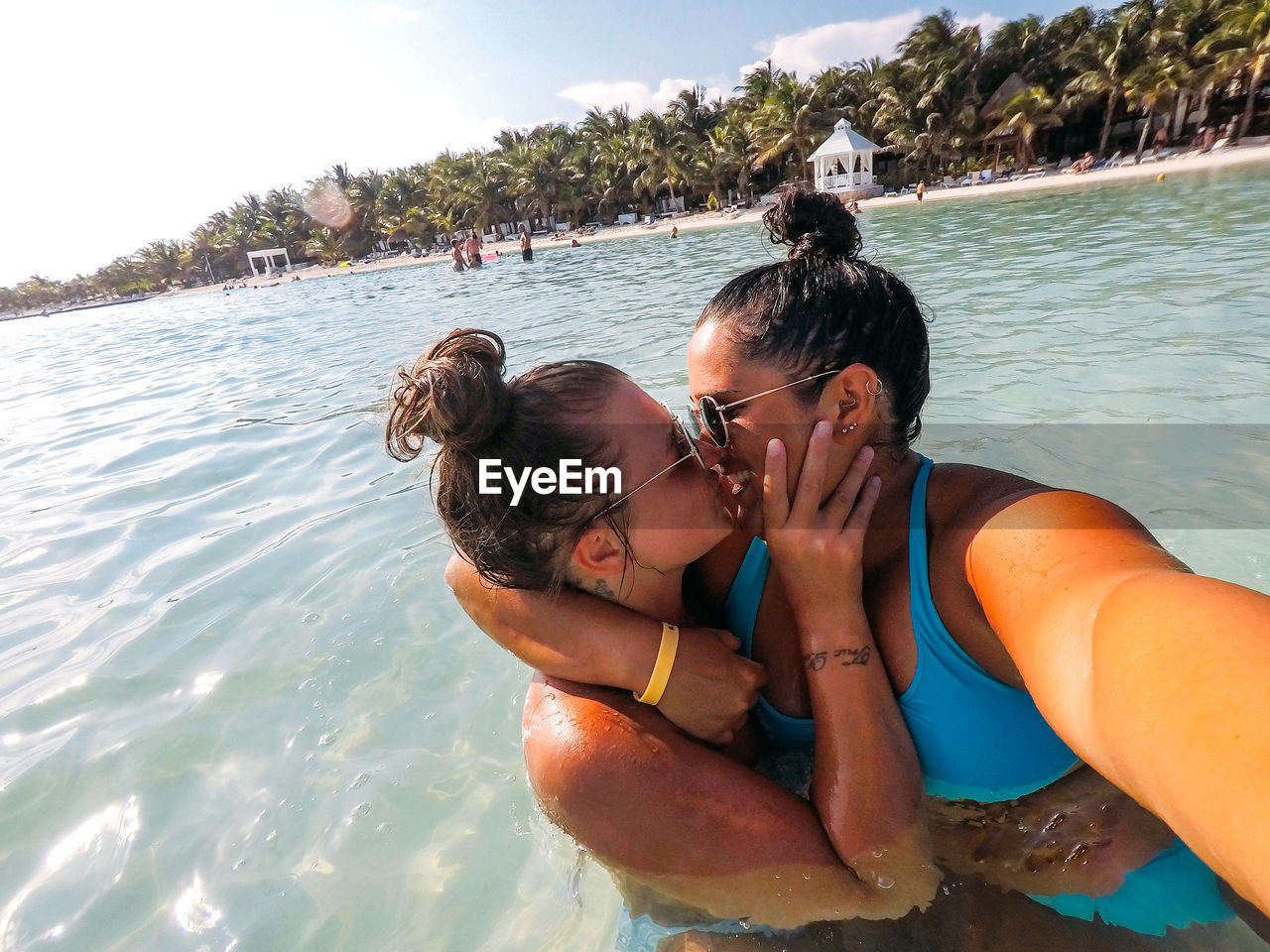 Smiling couple kissing in sea