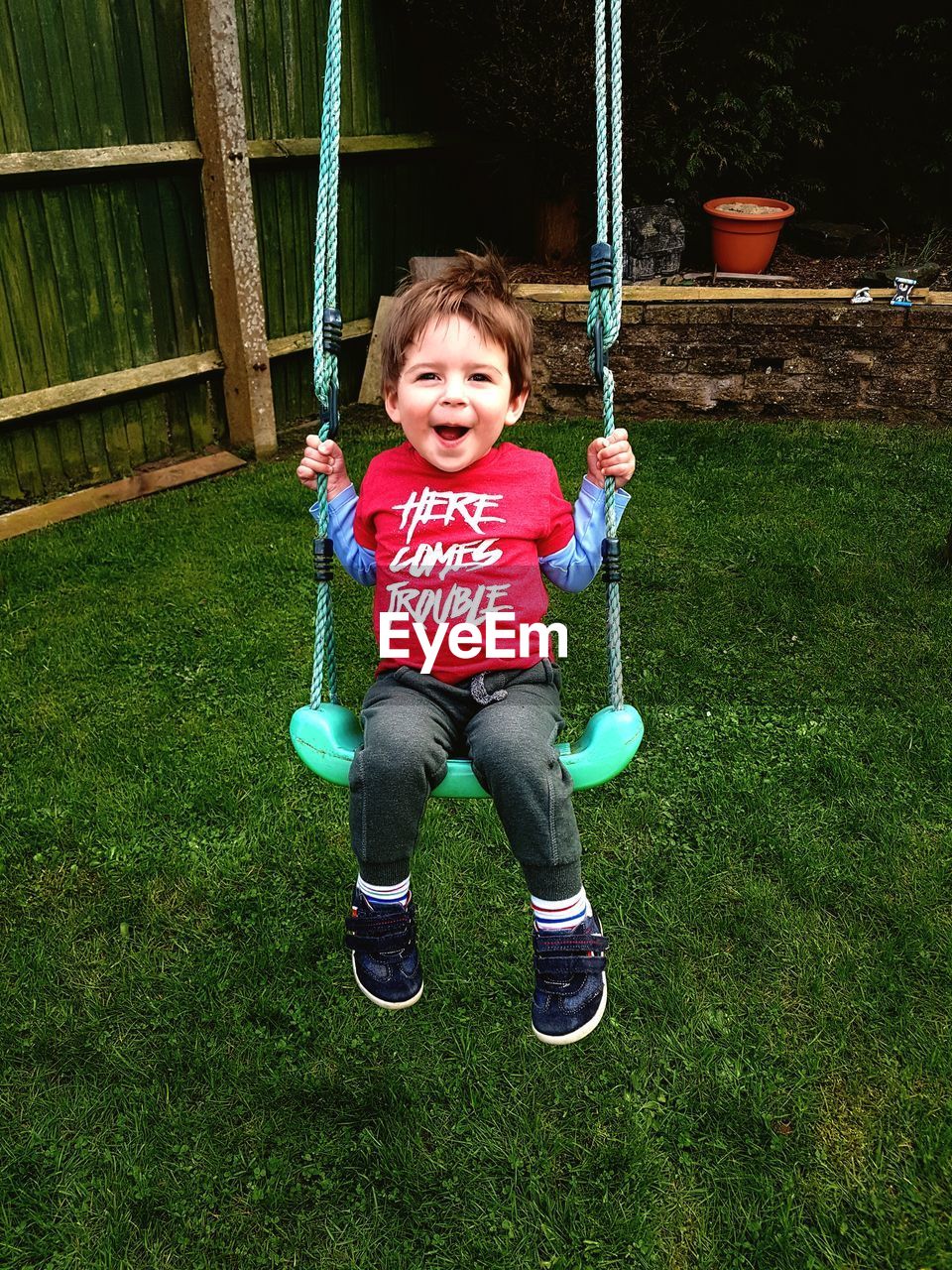 Portrait of smiling boy on swing