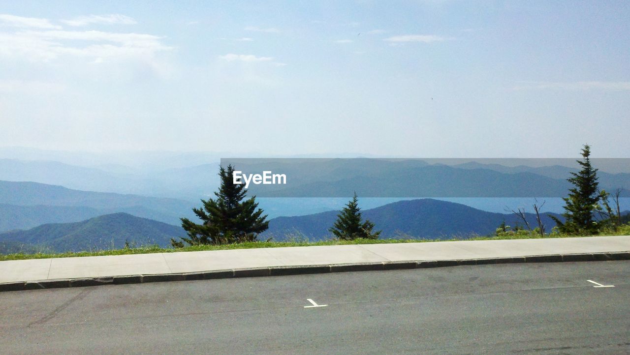 ROAD BY MOUNTAINS AGAINST SKY