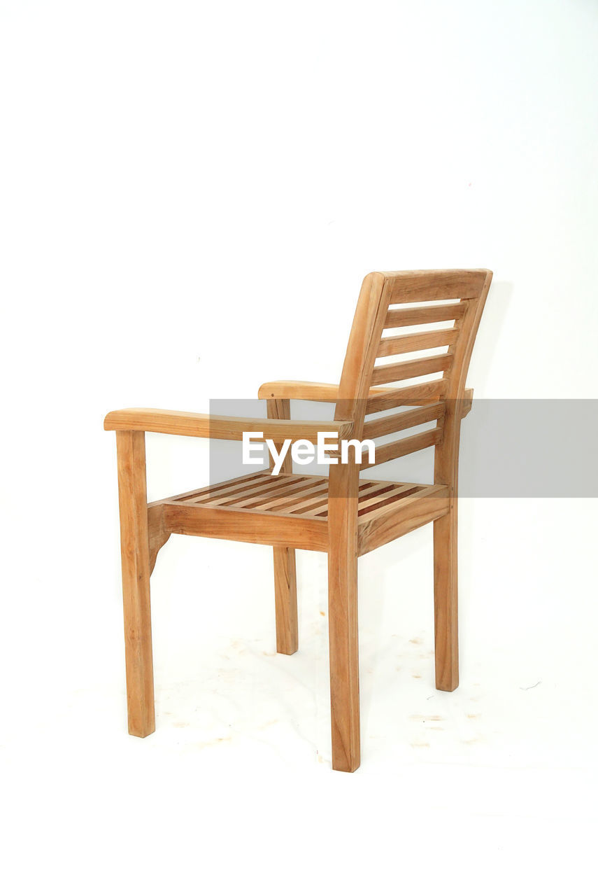 EMPTY CHAIR AGAINST WHITE BACKGROUND