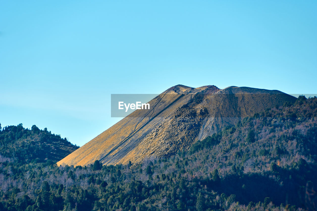 Scenic view of mountains against clear blue sky