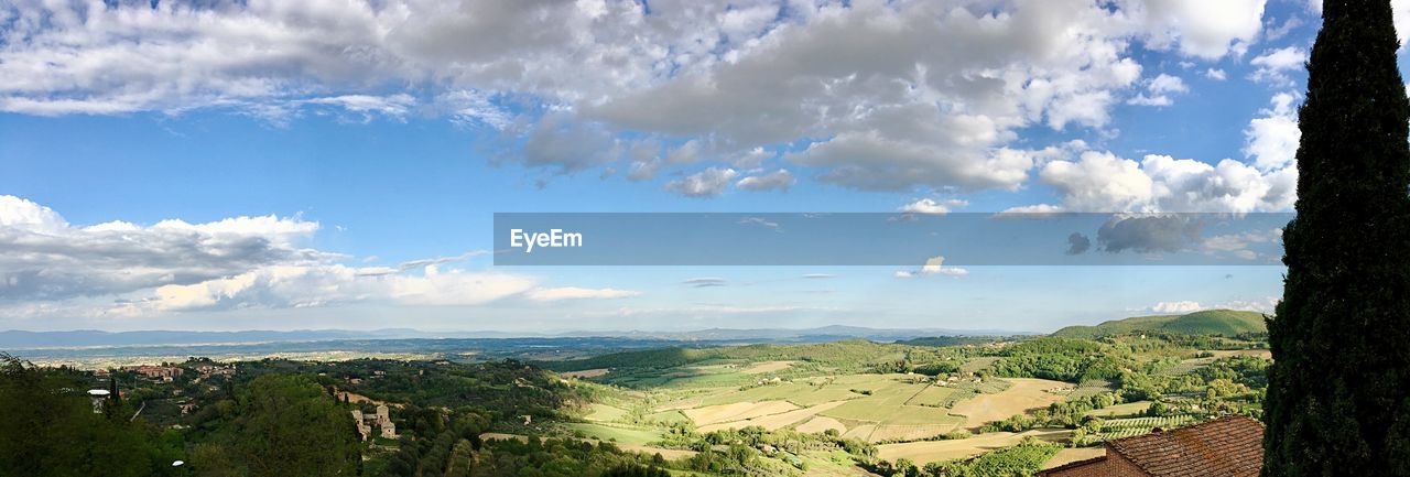 Panoramic view of trees and buildings against sky