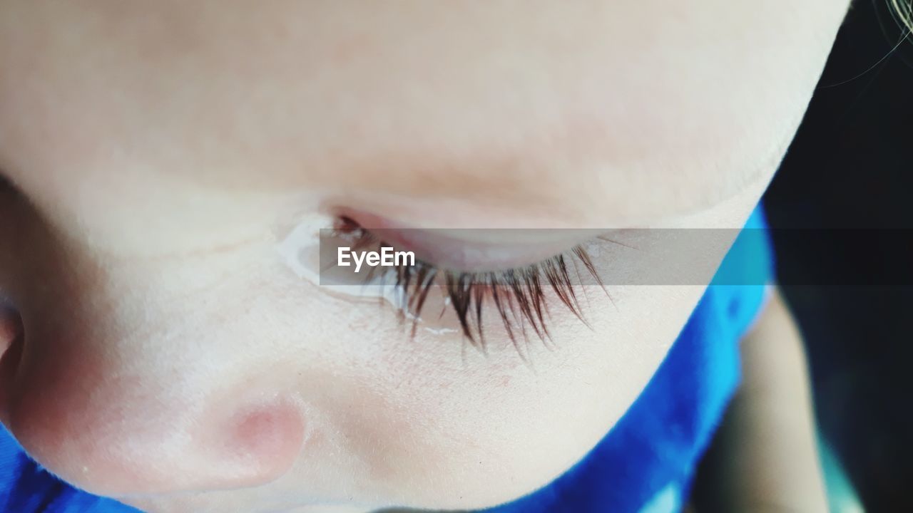 Close-up of baby boy crying while looking down