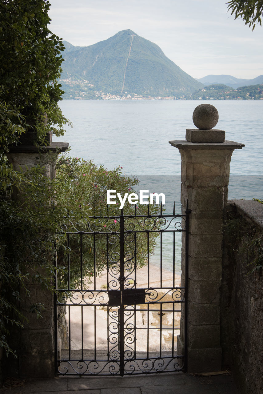 SCENIC VIEW OF SEA AGAINST MOUNTAIN