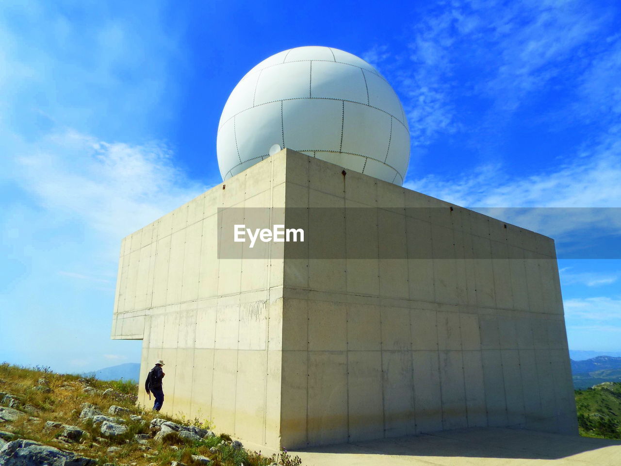 Woman standing by meteorological radar at tivissa