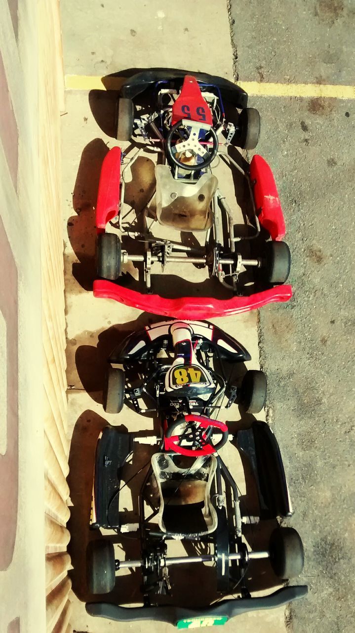 High angle view of go-carts by wall