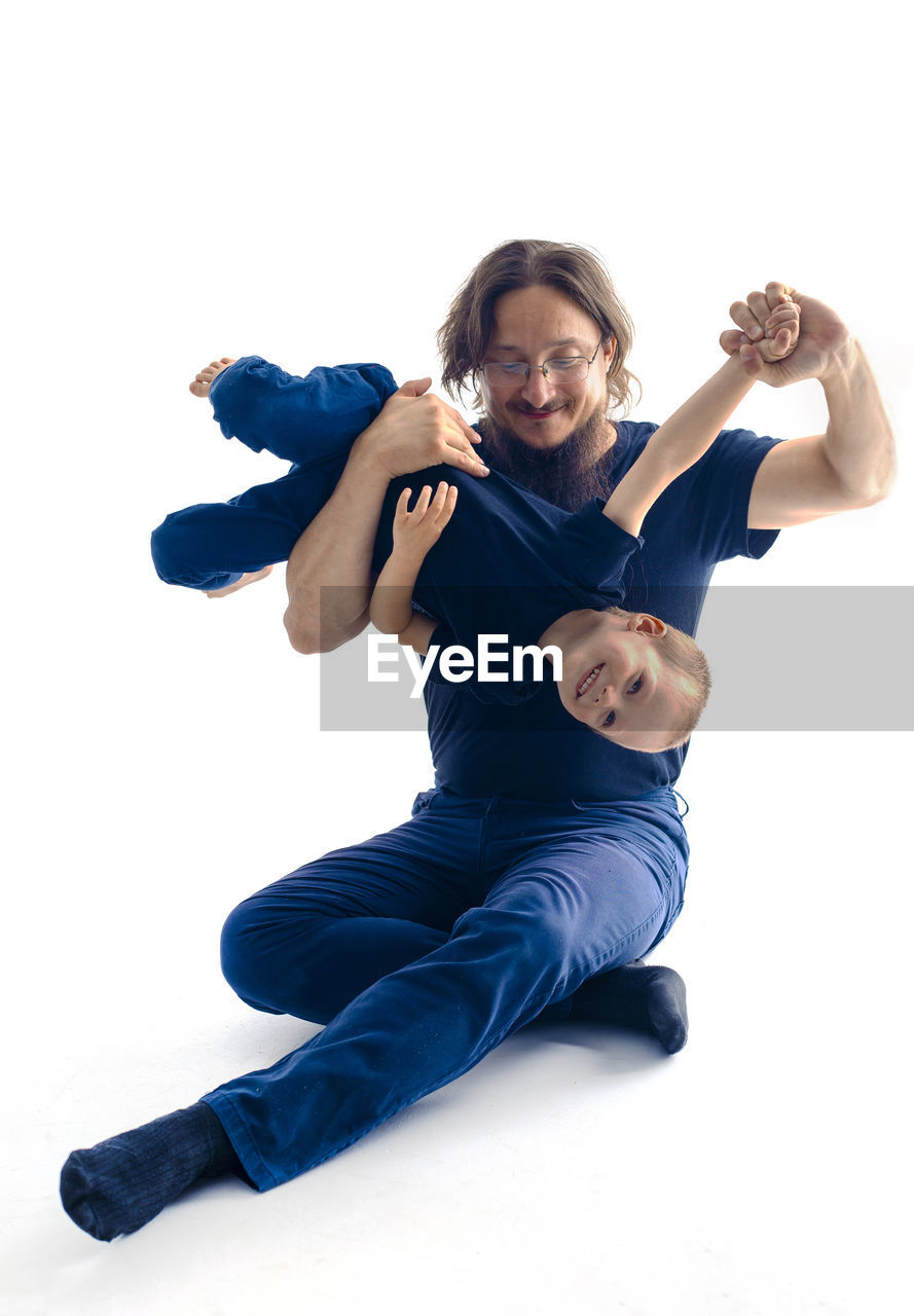white background, full length, cut out, adult, studio shot, one person, sports, portrait, smiling, young adult, modern dance, emotion, lifestyles, dancing, happiness, indoors, looking at camera, men, vitality, exercising, motion, activity, women, cheerful, casual clothing, positive emotion, athlete, strength