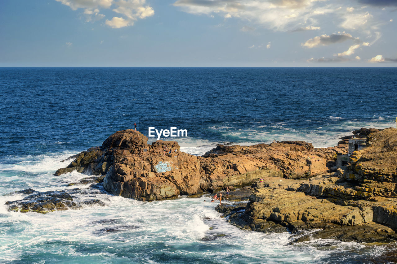 PANORAMIC VIEW OF SEA AND ROCKS AGAINST SKY