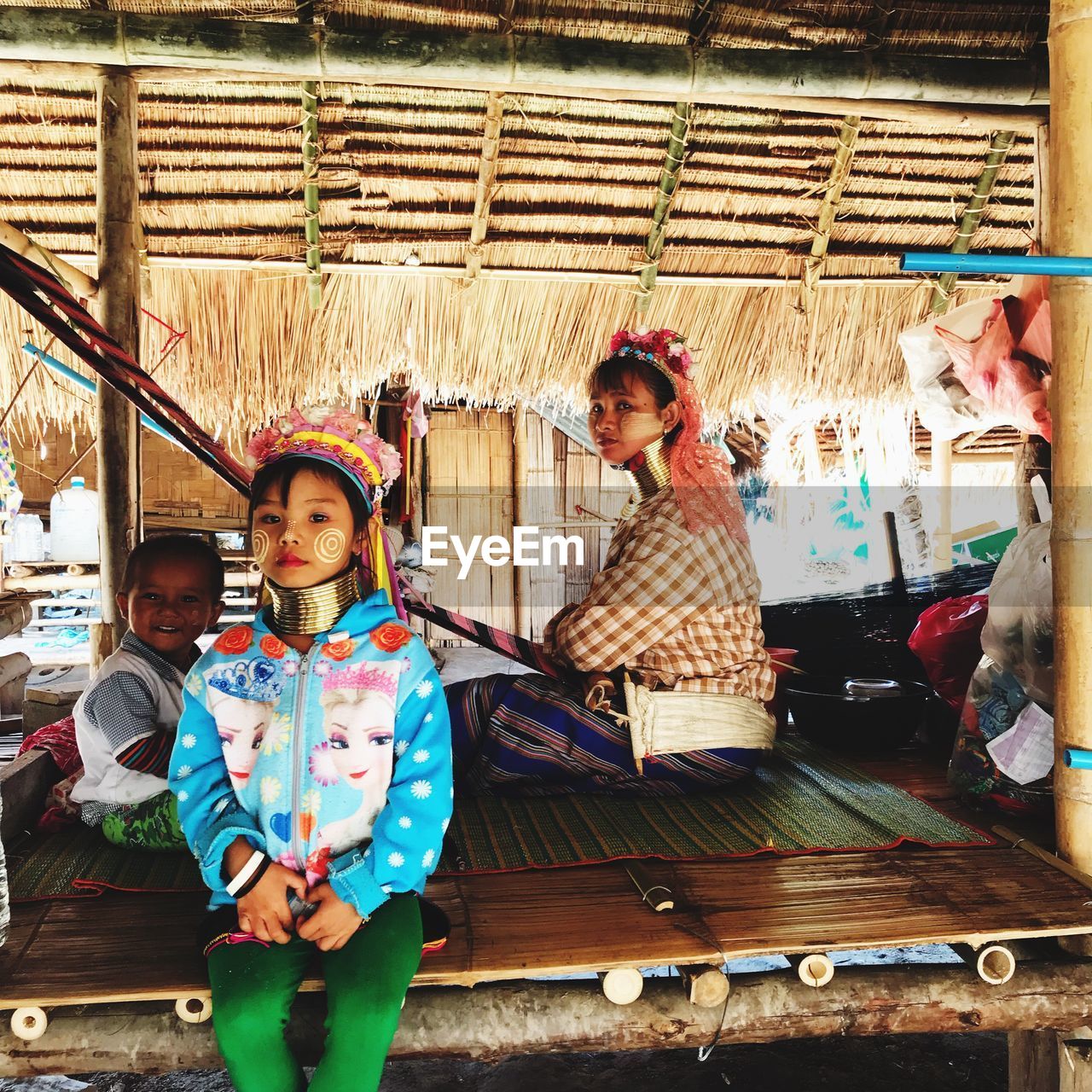 PORTRAIT OF MOTHER AND GIRL IN SHOPPING CART