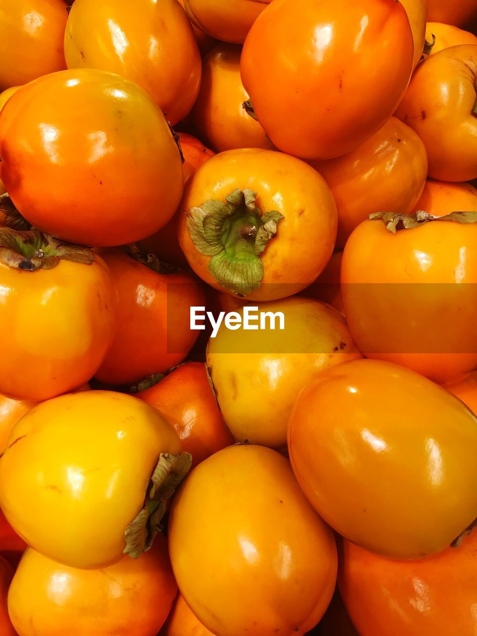 Full frame shot of persimmons for sale at market stall
