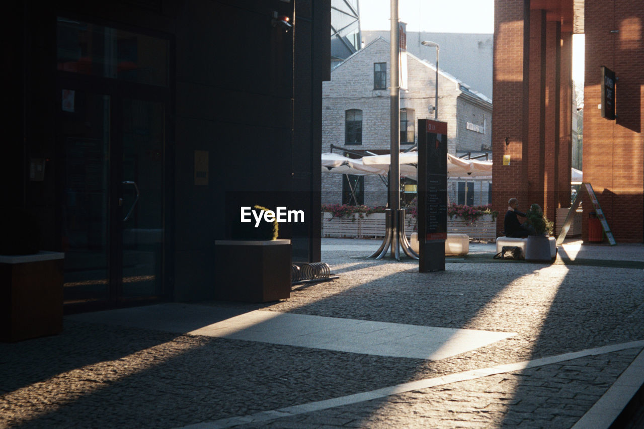 Street amidst buildings during sunny day