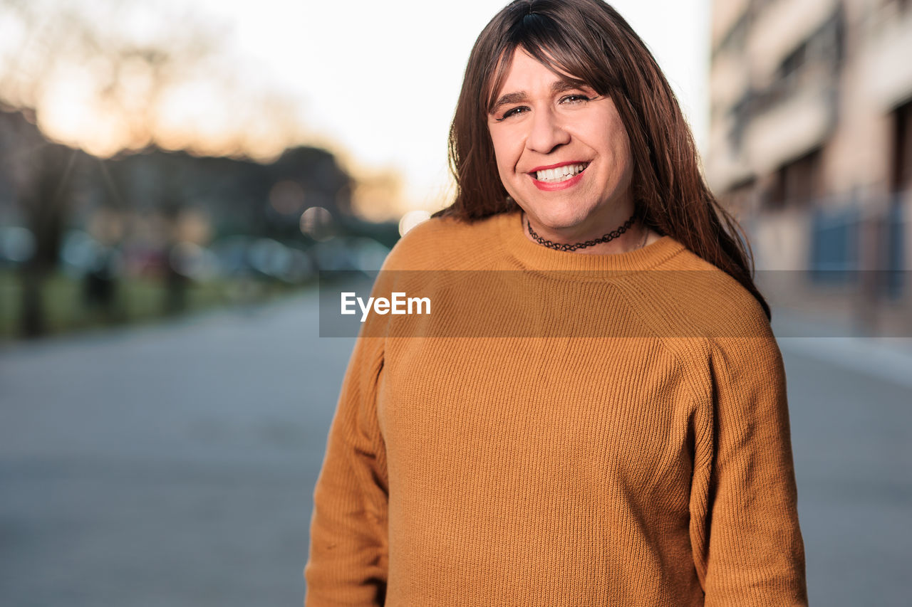 Portrait of transgender smiling on road