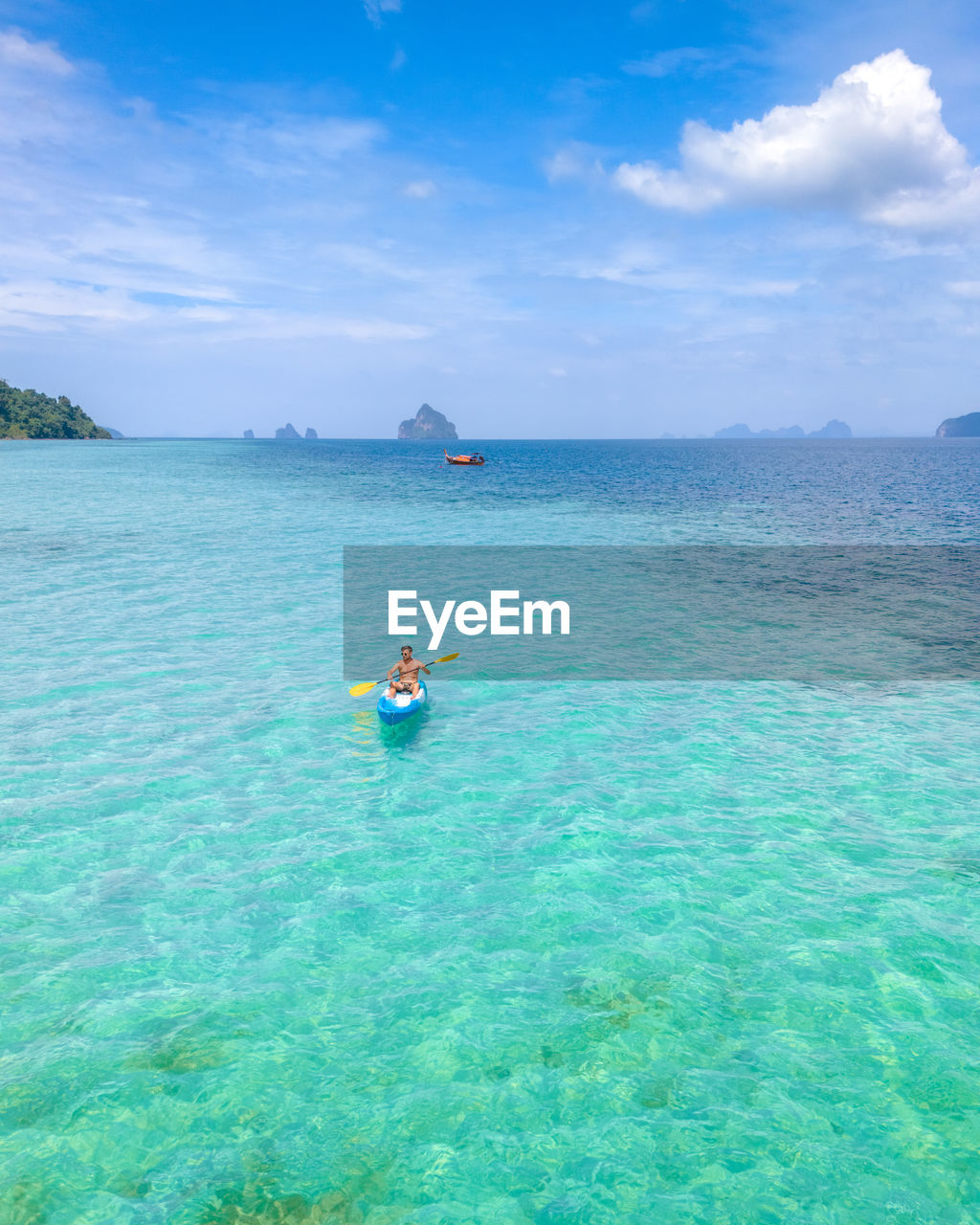 rear view of man diving in sea against sky